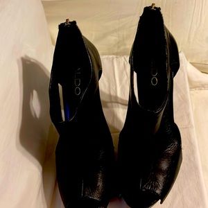 Black leather Aldo open toed heels. The zipper in the back is gold.